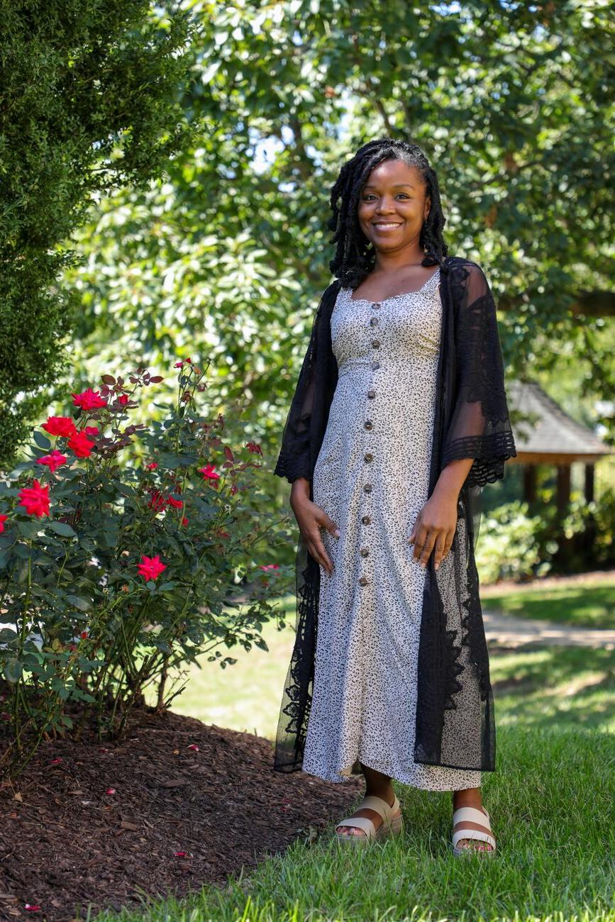 Photo of professor Lyneia Richardson standing outside in a garden.